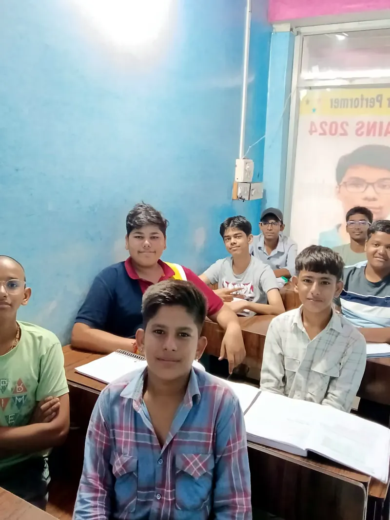A group of students at their desks in the DSM Classes classroom